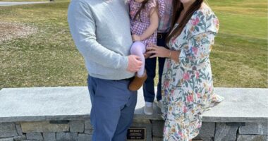 Family photo of two parents and two children.