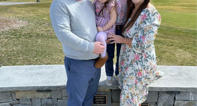 Family photo of two parents and two children.
