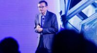 Intel CEO Lip Bu-Tan speaking at a conference.