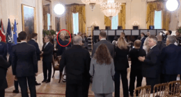 Trump speaking to someone in the Oval Office.