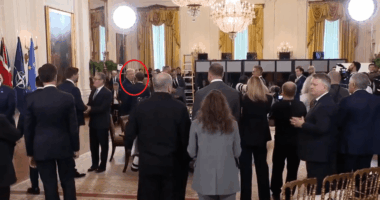 Trump speaking to someone in the Oval Office.