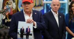 President Trump holding a photo of himself and President Putin.