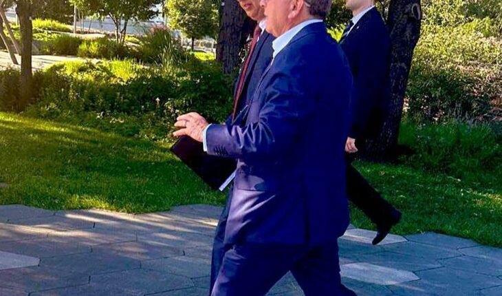 Steve Witkoff and Kirill Dmitriev walking in a park.