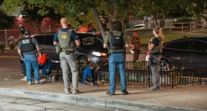 FBI, ATF, and U.S. Park Police officers assisting a woman experiencing apparent synthetic marijuana side effects.