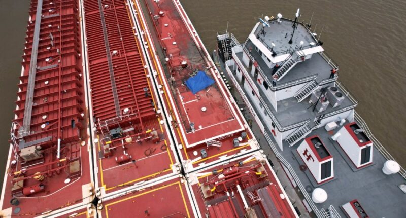 Two die when helicopter strikes powerlines and crashes into a barge on the Mississippi River