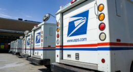 Row of USPS delivery trucks.
