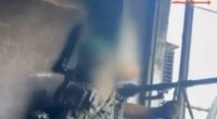 Blurry image of a sniper aiming a rifle.