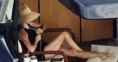 Victoria Beckham basks in a swimsuit while David dives into new read