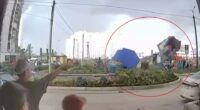 Bouncy castle with children inside lifted into the air by strong winds.