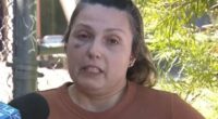 Woman with a black eye being interviewed.