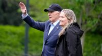President Joe Biden waves alongside Deputy White House Chief of Staff Annie Tomasini