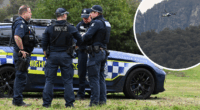 Manhunt for 'heavily armed' accused cop killer into second day