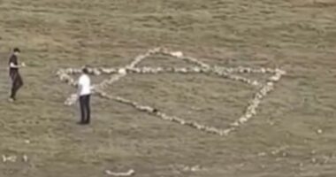 Moment Jewish holidaymakers dismantle hillside Christian cross and use stones to create giant Star of David instead