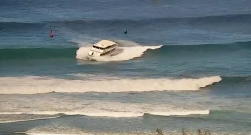 Passenger boat runs aground in high surf off Hawaii beach