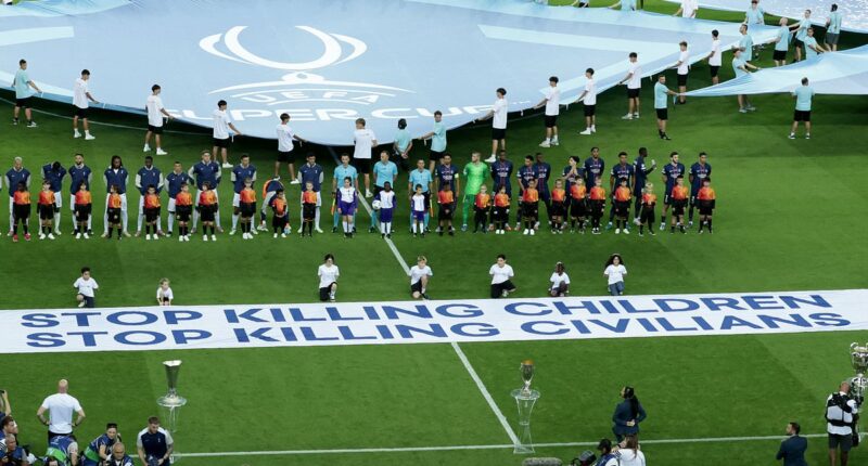 UEFA claim their 'Stop killing children' Super Cup banner is NOT political after sparking Israeli anger with gesture days after Mohamed Salah criticised their tribute to 'Palestinian Pele'