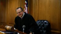 Judge Frank Caprio smiling in his courtroom.