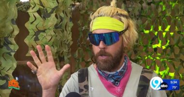 Man with blond hair and sunglasses speaks to camera about Bigfoot.