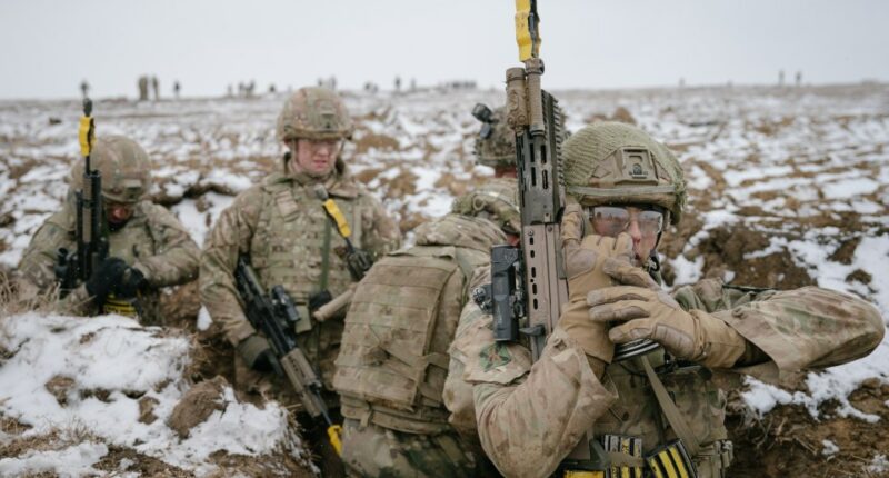SMARDAN, ROMANIA - FEBRUARY 17: A British soldier reloads his gun on February 17, 2025 in Smardan, Romania. The UK's 1st Division is commanding land forces during Exercise Steadfast Dart, as NATO Allied Reaction Force (ARF) training continues in Romania. The ARF was established in July 2024 amid a restructuring of the Alliance's high-readiness forces, with the capability of rapidly reinforcing NATO's eastern flank. The exercise includes 10,000 service personnel from nine nations, carried out across Romania, Greece, and Bulgaria during January and February. Steadfast Dart marks the first full-scale operational deployment of ARF, and this week coincides with the third anniversary of Russia's large-scale invasion of Ukraine in 2022. (Photo by Andrei Pungovschi/Getty Images) *** BESTPIX ***