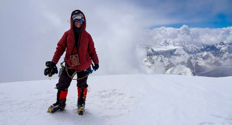 Natalia Nagovitsina, a Russian climber, on a snowy mountaintop.