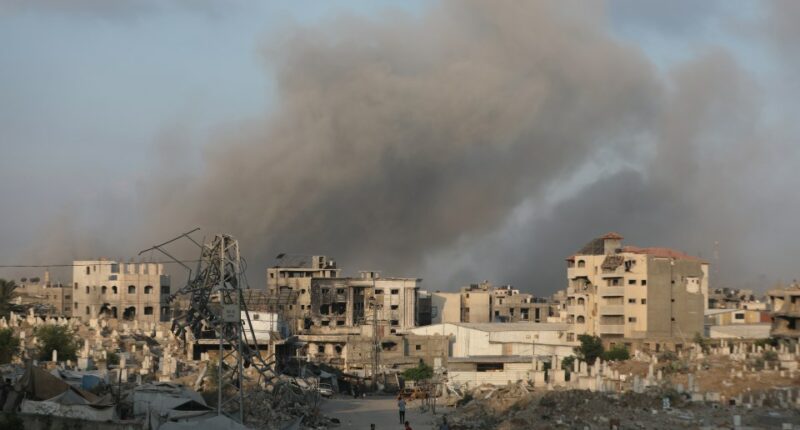 Smoke rises over damaged buildings and a cemetery in Gaza City after airstrikes.