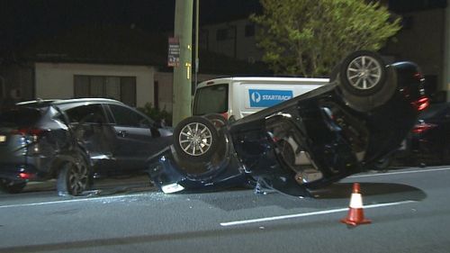 Footage has captured the moment an allegedly drunk driver returned to the scene of a dramatic crash in Sydney's south-west and was swiftly arrested by police.