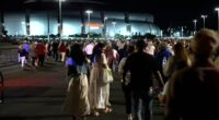 Attendees gather outside hours before Charlie Kirk’s memorial begins