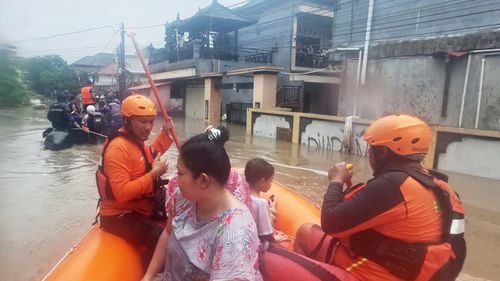Officials say the flood waters have claimed at least two lives including a pregnant woman who was swept away.