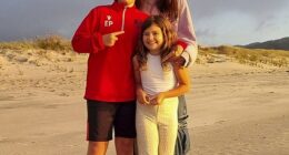 Pictured: Kim with her children Elijah and Willow on a beach in New Zealand after the family moved there in June