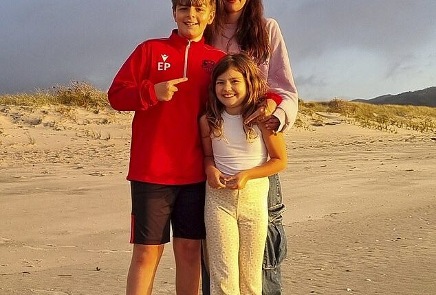 Pictured: Kim with her children Elijah and Willow on a beach in New Zealand after the family moved there in June