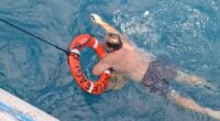 Fisherman is rescued after treading water for eight hours at sea, second fisherman remains missing