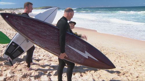 Friends of the man killed in a shark attack in Sydney's Northern Beaches last week have returned to the scene to conquer their fear.