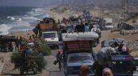 Displaced Palestinians fleeing northern Gaza carry their belongings along the coastal road toward southern Gaza, Tuesday, Sept. 9, 2025, after the Israeli army issued evacuation orders from Gaza City. (AP Photo/Jehad Alshrafi)