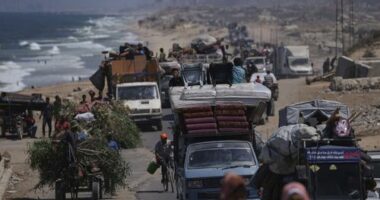 Displaced Palestinians fleeing northern Gaza carry their belongings along the coastal road toward southern Gaza, Tuesday, Sept. 9, 2025, after the Israeli army issued evacuation orders from Gaza City. (AP Photo/Jehad Alshrafi)