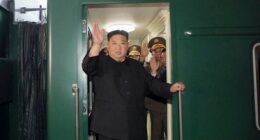 North Korea leader Kim Jong Un waves from a train in Pyongyang, North Korea.