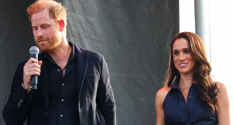Meghan Markle is branded 'needy and clingy' by royal fans as she 'grabs' Prince Harry during his moment on stage at charity concert