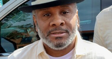 Bryan Hooper Sr. wearing dress shirt and hat