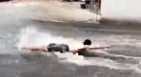 Moment man tries to swim through the streets of flooded Benidorm