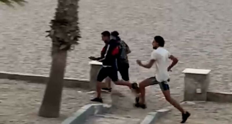 Moment migrants arrive on Spanish beach 'before running through hotel'