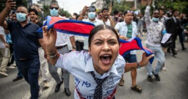 A demonstrator shouts slogans during a protest outside the Parliament in Kathmandu.