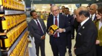 Prime Minister Anthony Albanese, with  Lulu Global Director, Global Operations & Chief Sustainability Officer Mohamed Althaf MM (left) and Lulu Chairman M. A. Yusuff Ali (right) during a visit to Lulu Hypermarket, which imports Australian goods to the UAE,  at Mushrif Mall in Abu Dhabi, United Arab Emirates on September 29, 2025.