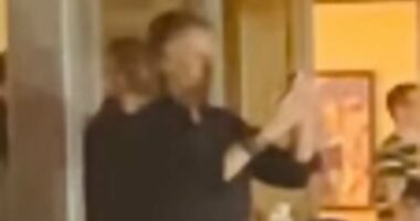 Paul McCartney is seen filming Oasis as he joins A-listers at gig