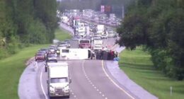 Pickup pulling camper overturns in crash with big rig on I-95 in Volusia County
