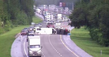 Pickup pulling camper overturns in crash with big rig on I-95 in Volusia County