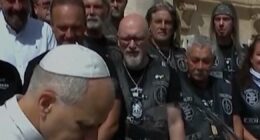 Pope Leo poses with motorbike for charity auction