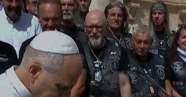 Pope Leo poses with motorbike for charity auction