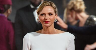 Princess Charlene of Monaco, 47, stuns in a showstopping white backless gown during solo appearance at the Ballon D'Or - and makes rare reference to her time as an Olympic athlete