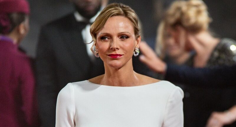 Princess Charlene of Monaco, 47, stuns in a showstopping white backless gown during solo appearance at the Ballon D'Or - and makes rare reference to her time as an Olympic athlete