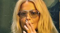 Rita Ora lights up a cigarette outside her hotel after the Prada show