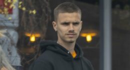 Romeo Beckham shops for cheap jewellery at a market in Notting Hill