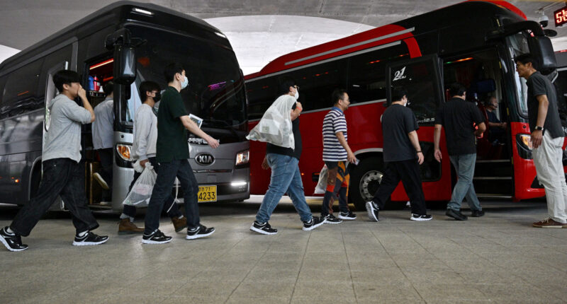 South Koreans detained in U.S. immigration raid arrive back home to applause and protests